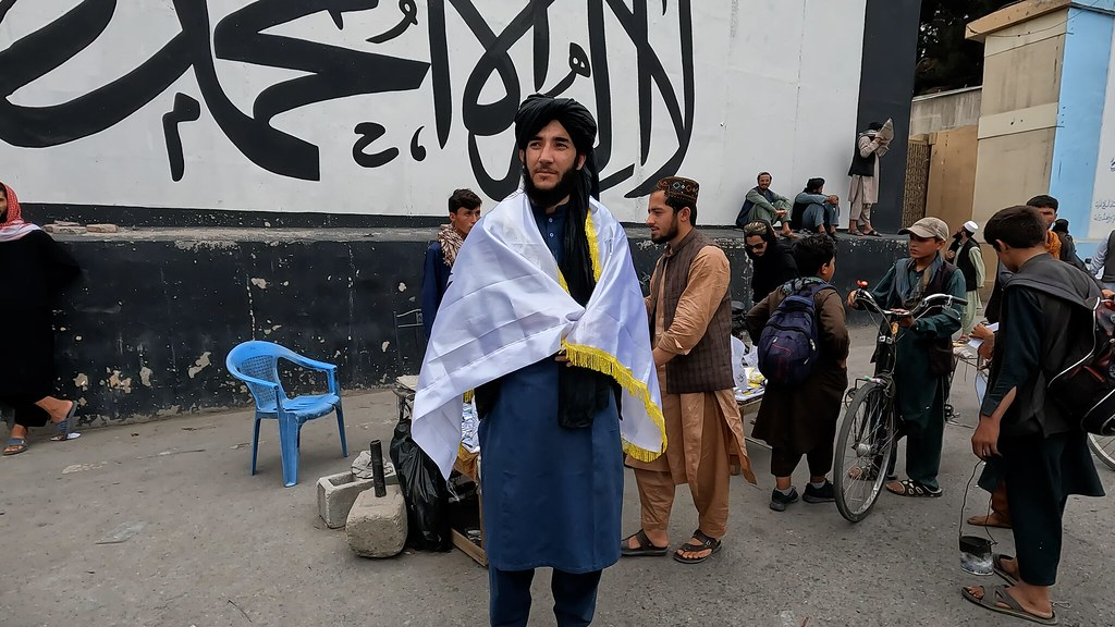 Taliban poses with flag outside American Embassy in Kabul