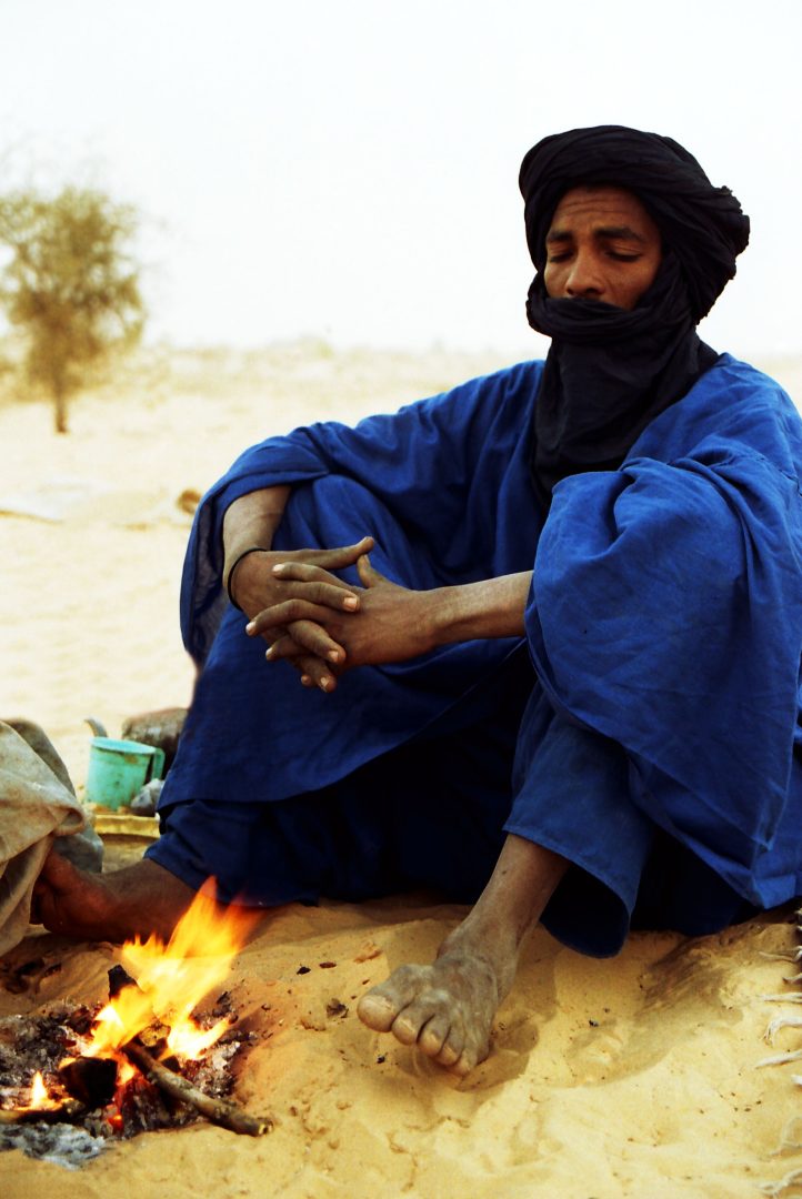 A Tuareg in northern Mali prepares a fire for making tea