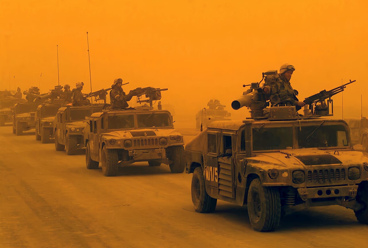 A convoy of U.S. Marine Corps (USMC) High-Mobility Multipurpose Wheeled Vehicles (HMMWV) arrives in Northern Iraq